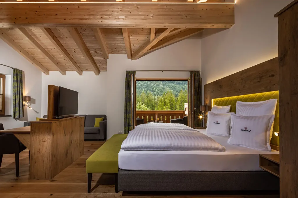 Wohlfühl-Suite Refugium R6 mit Boxspringbett, Sitzecke, Sichtdachstuhl und Zugang zur Loggia
